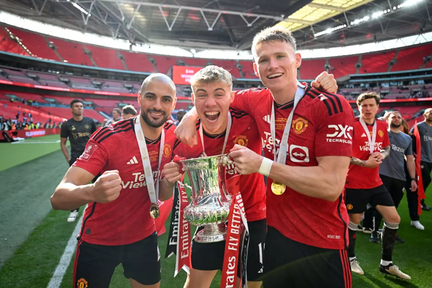 Scott McTominay (right) celebrates with Sofyan Amrabat and Rasmus Hojlund after Man Utd win the 2024 FA Cup -